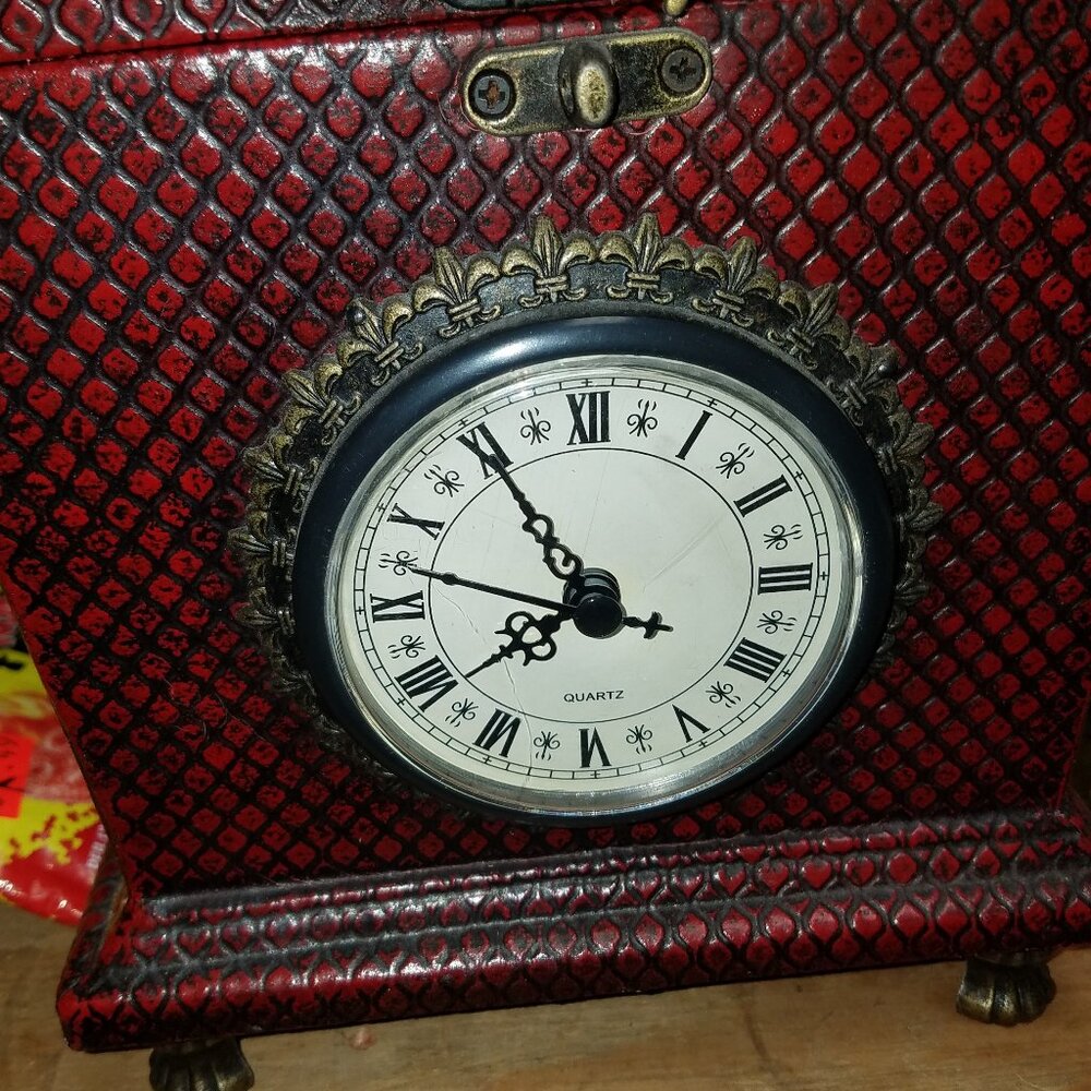 clock set in woven box has arched lid with brass clasp about 10 inch's tall